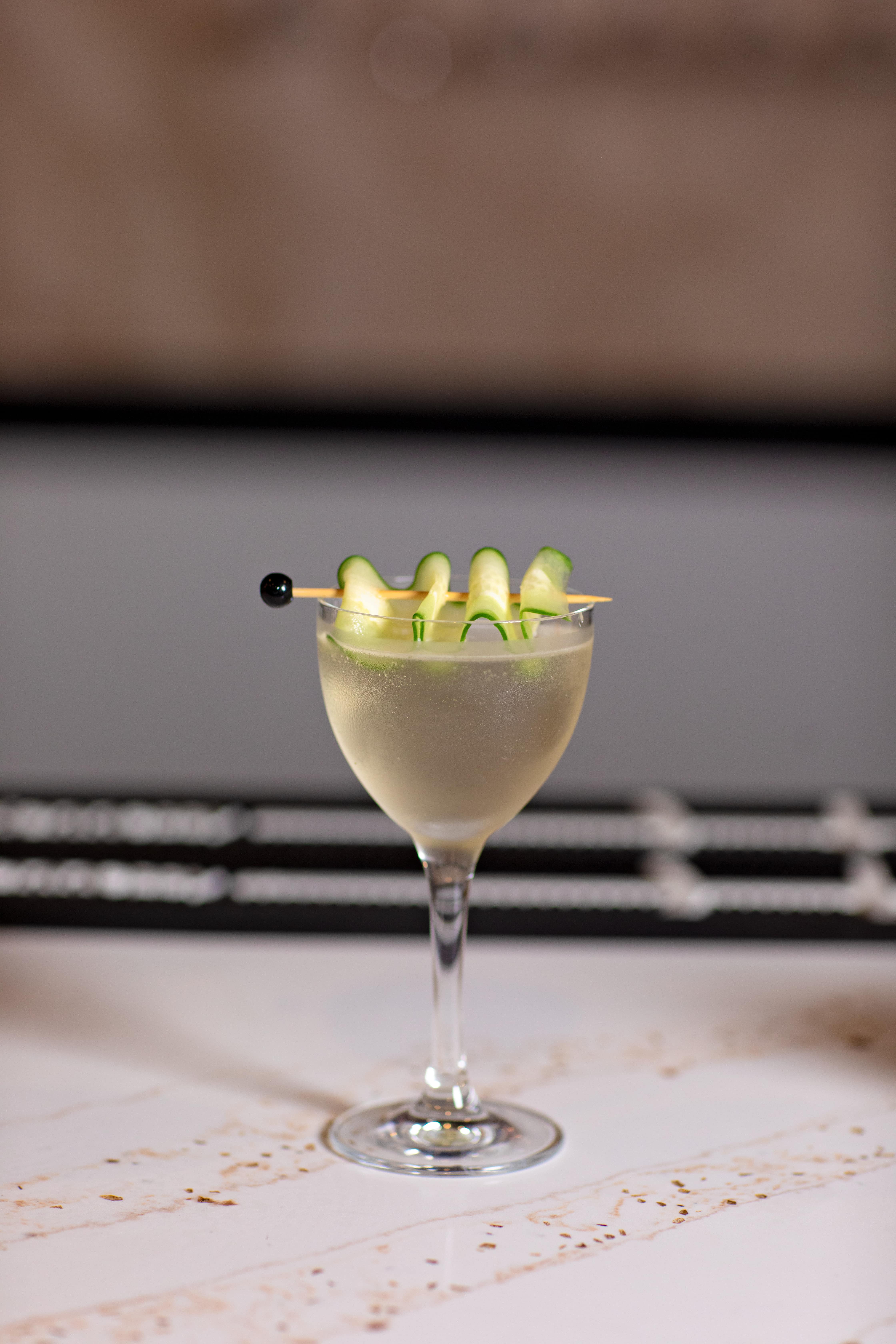 Cucumber martini with a ribbon garnish
