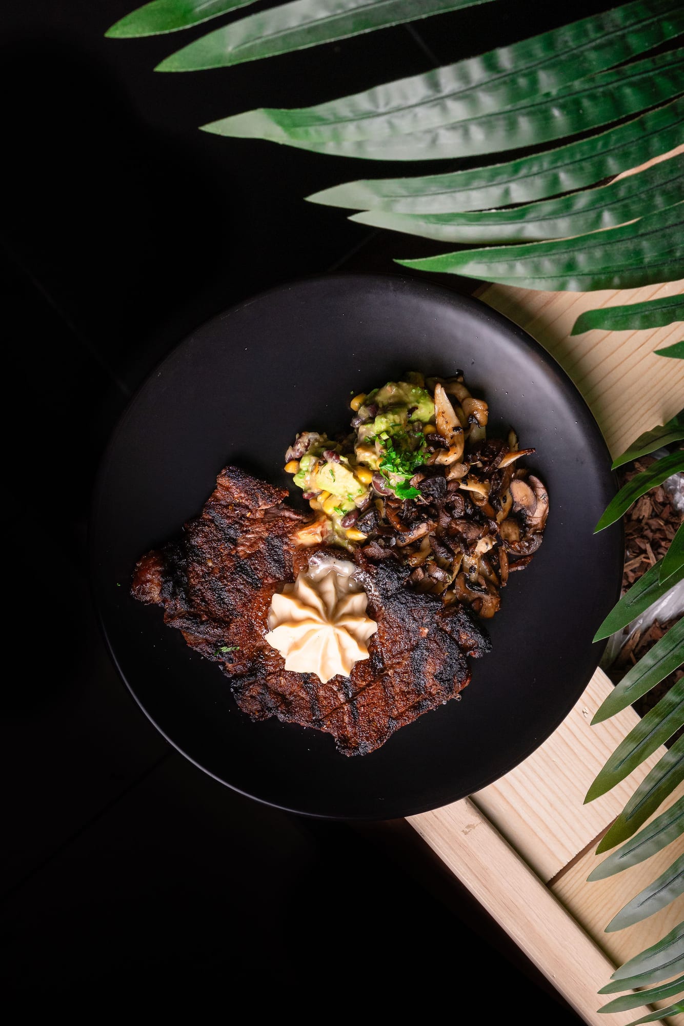 Blackened steak with roasted mushrooms and a pat of herb butter