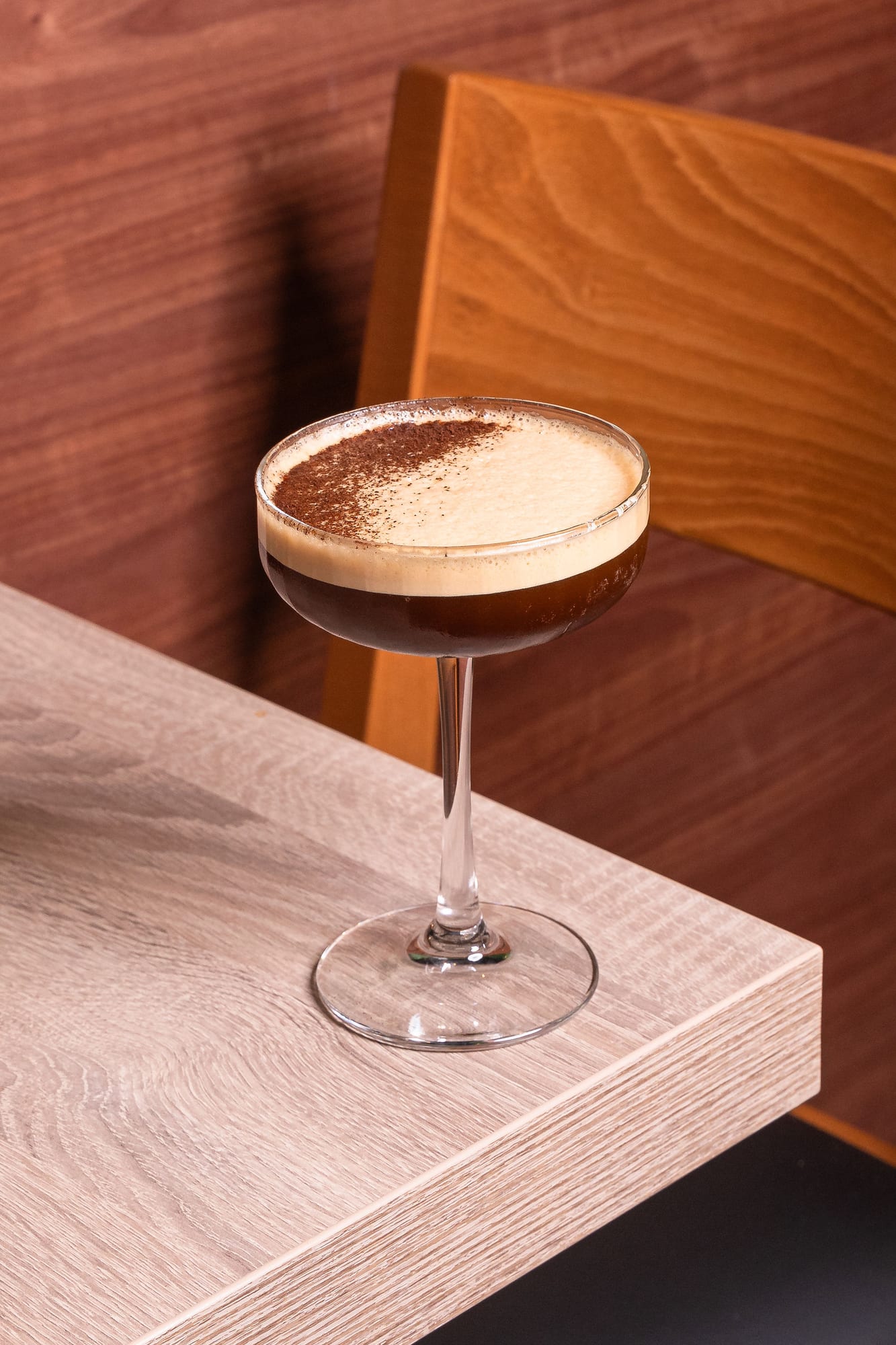 An espresso martini with a cocoa-dusted foam