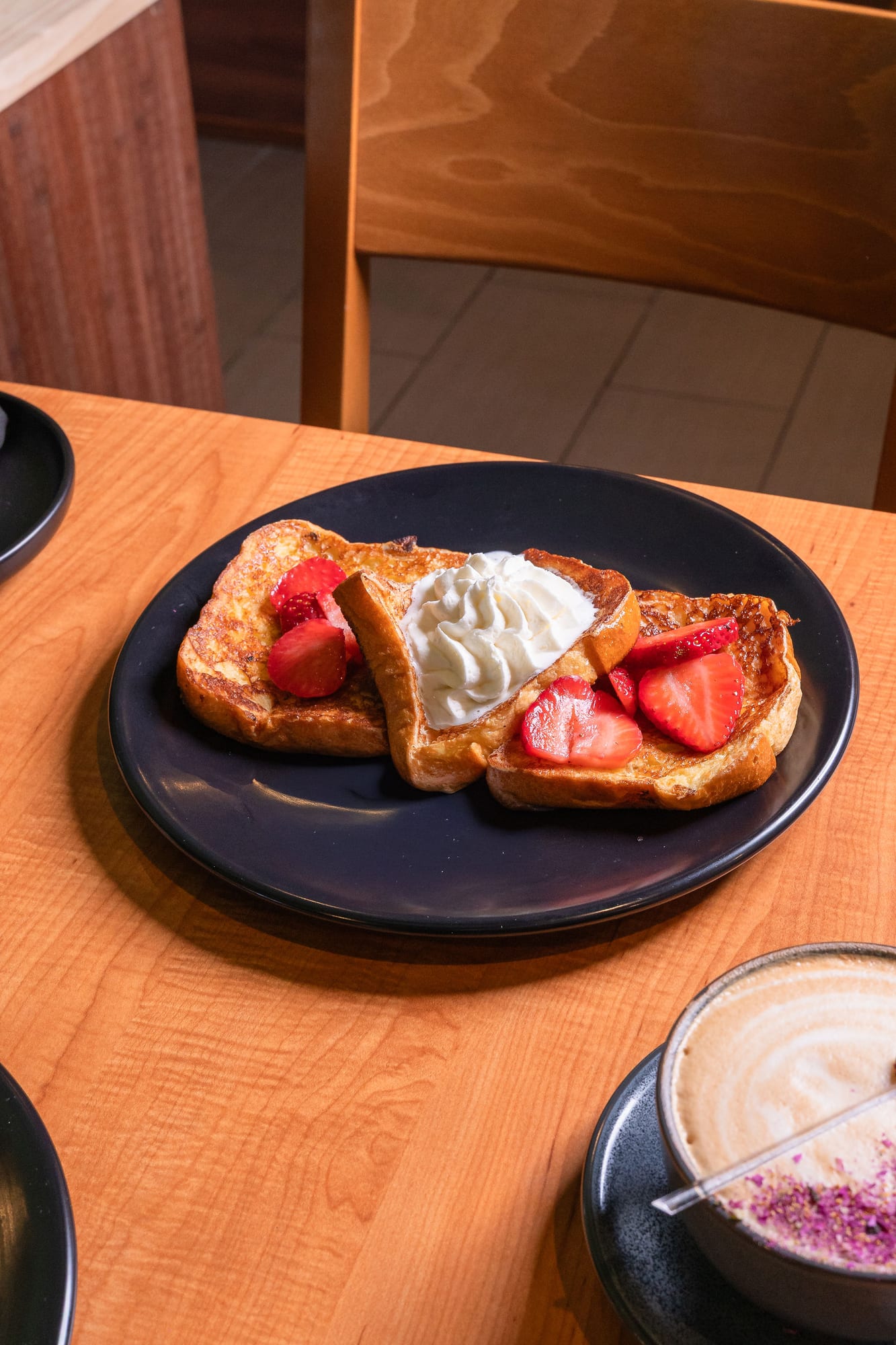 French toast topped with fresh strawberries and whipped cream