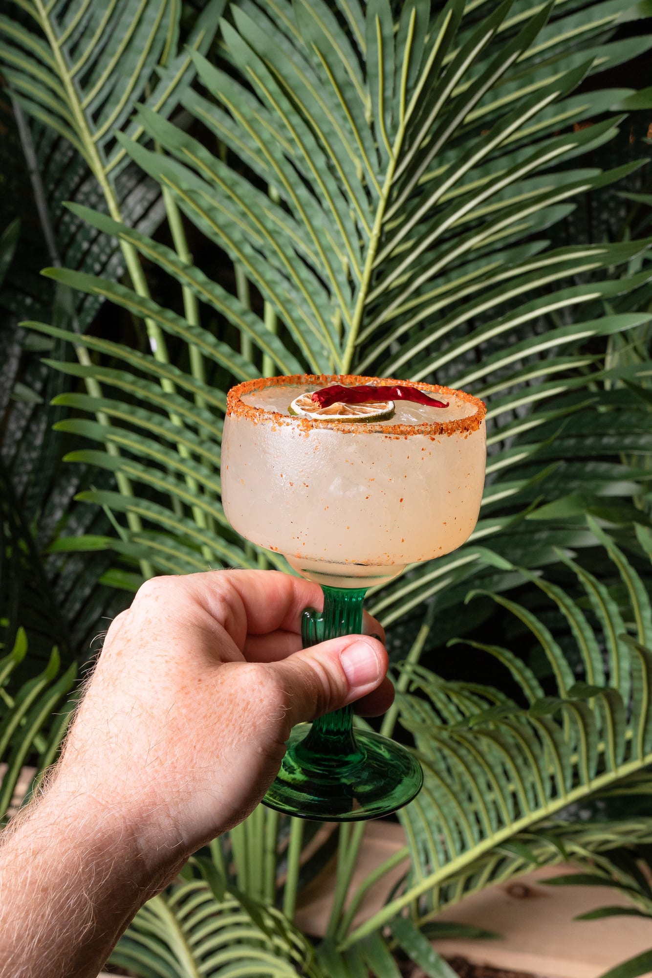 A tajin-rimmed margarita in a cactus-stem glass