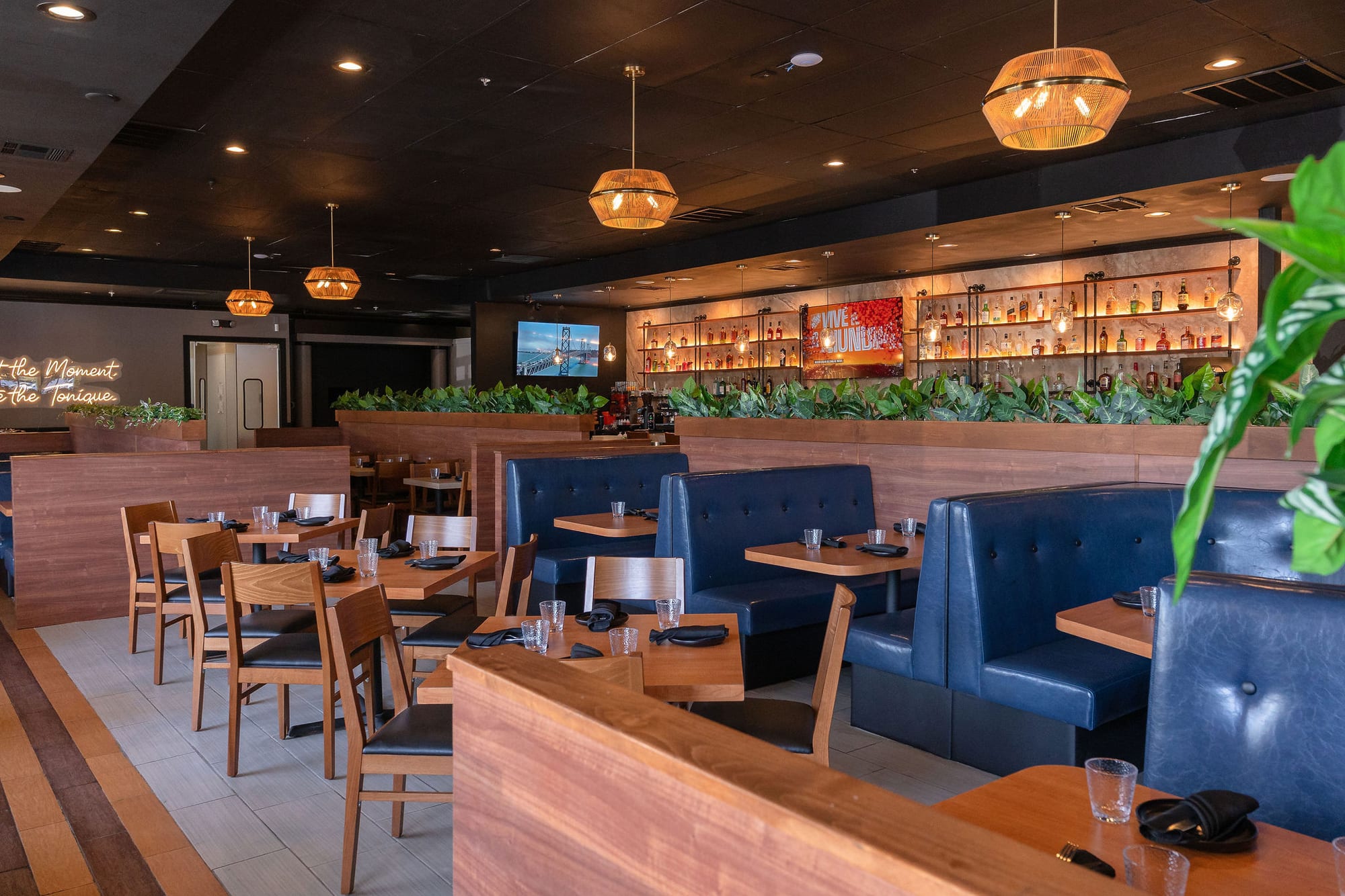 The dining room with blue leather booths and globe pendant lights
